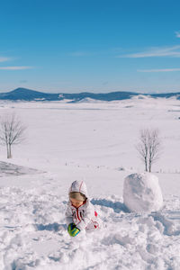 Man skiing on snow covered landscape