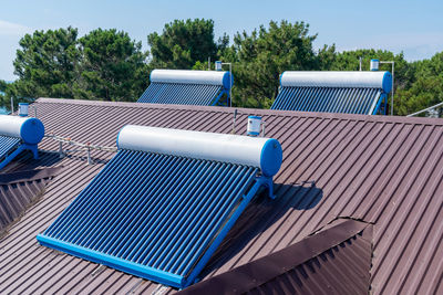 Tilt image of basketball hoop against blue sky