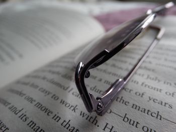 Close-up of eyeglasses on open book