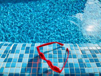 High angle view of red floating on swimming pool