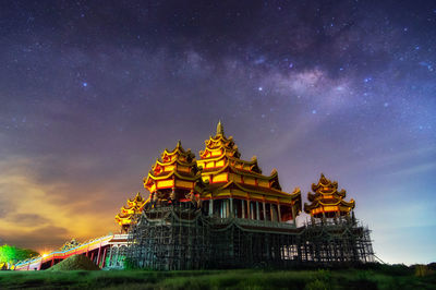 Low angle view of temple against star field at night