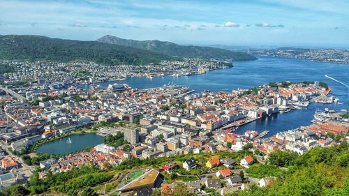 High angle view of townscape by sea against sky