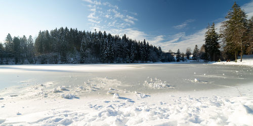 Snow covered field against sky