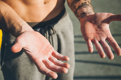 Midsection of man showing hands