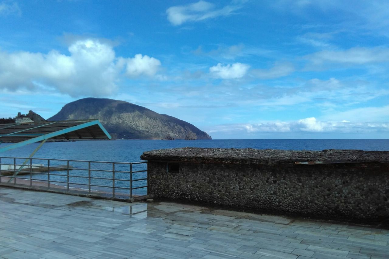 sky, sea, water, cloud - sky, tranquil scene, tranquility, scenics, blue, mountain, cloud, horizon over water, beauty in nature, beach, nature, day, idyllic, railing, cloudy, built structure, shore