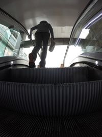 Low angle view of man on ceiling