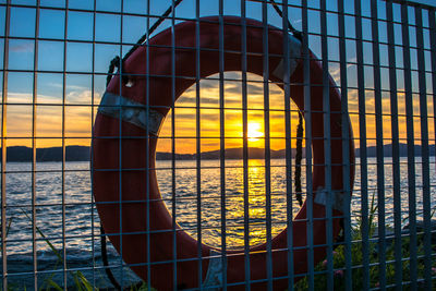 Close-up of sea against orange sky