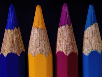 Close-up of multi colored pencils against black background