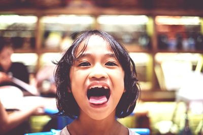 Portrait of girl sticking out tongue