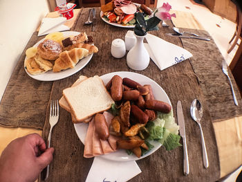 Cropped image of man having food in restaurant