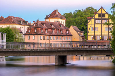 Bridge over river with buildings in background