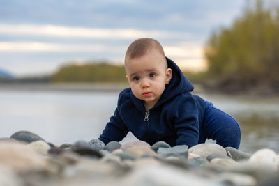 Portrait of boy looking at lake