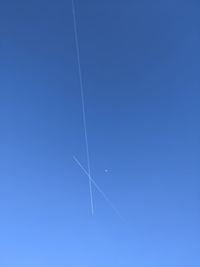 Low angle view of vapor trails in sky