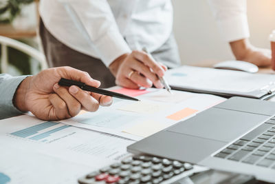 Cropped image of man working on table