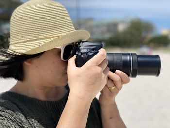 Rear view of woman photographing with camera