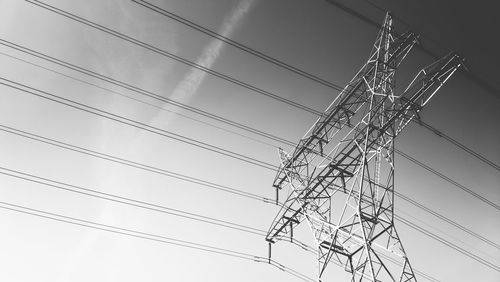 High section of electricity pylon against clear sky