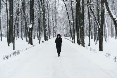 Man in snow covered forest