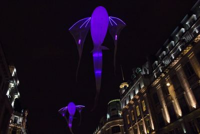 Low angle view of illuminated building at night
