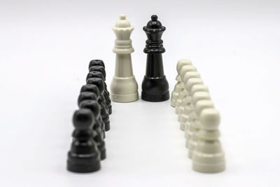 Close-up of chess pieces against white background