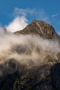 Cloud by mountain against sky