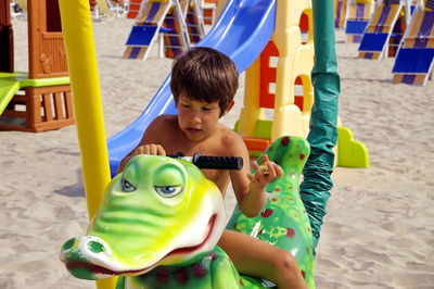 Boy playing with toy on beach