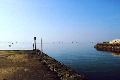 Scenic view of sea against clear blue sky