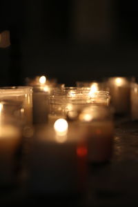 Close-up of illuminated tea light candles at night