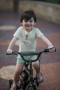 Portrait of cute girl riding bicycle