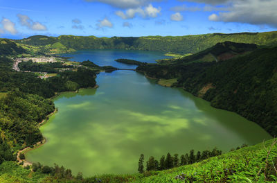 Scenic view of lake amidst mountains against sky