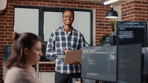 Portrait of smiling businessman at office