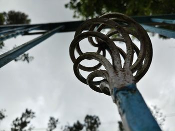 Low angle view of metal against sky