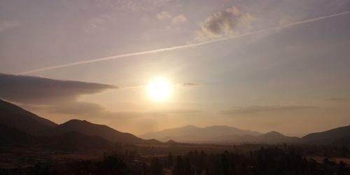 Scenic view of silhouette mountains against sky during sunset