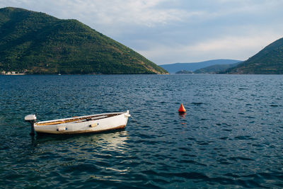 Boat floating on sea against sky