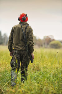 Rear view of man standing on field