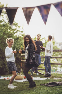 Female friends dancing at rooftop party