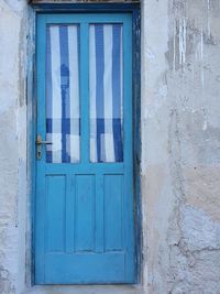 Closed blue window of old building