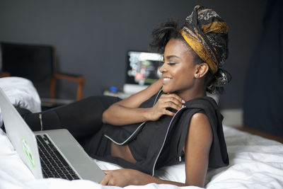 Young woman looking at her laptop