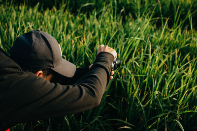 Midsection of man wearing hat on field