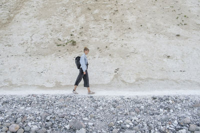 Full length of a man standing on rock