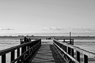 Pier over sea against sky