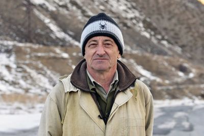 Portrait of man standing in snow