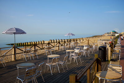 Eastbourne,u.k. empty cafe and beach in early morning sunshine.