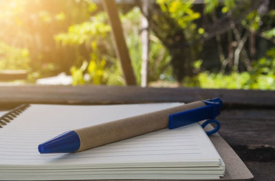 Pen , notebook on a wooden table