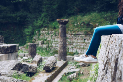 Side view of woman sitting outdoors