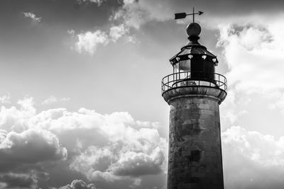 Low angle view of lighthouse against cloudy sky