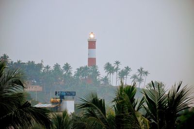 Lighthouse against sky in city