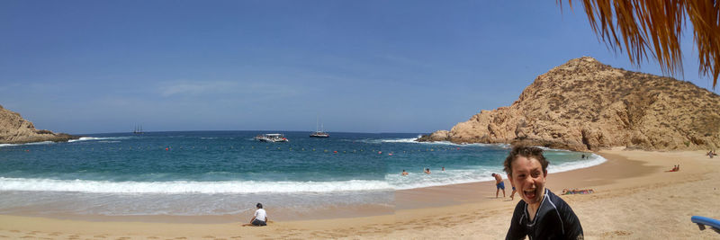 Panoramic view of beach against clear sky