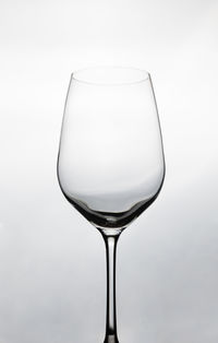 Close-up of wineglass against white background