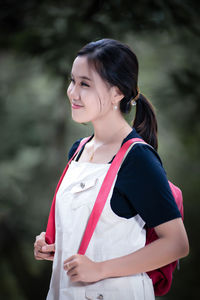Portrait of young woman standing outdoors
