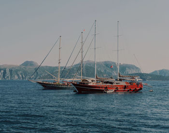 Boats in sea against sky